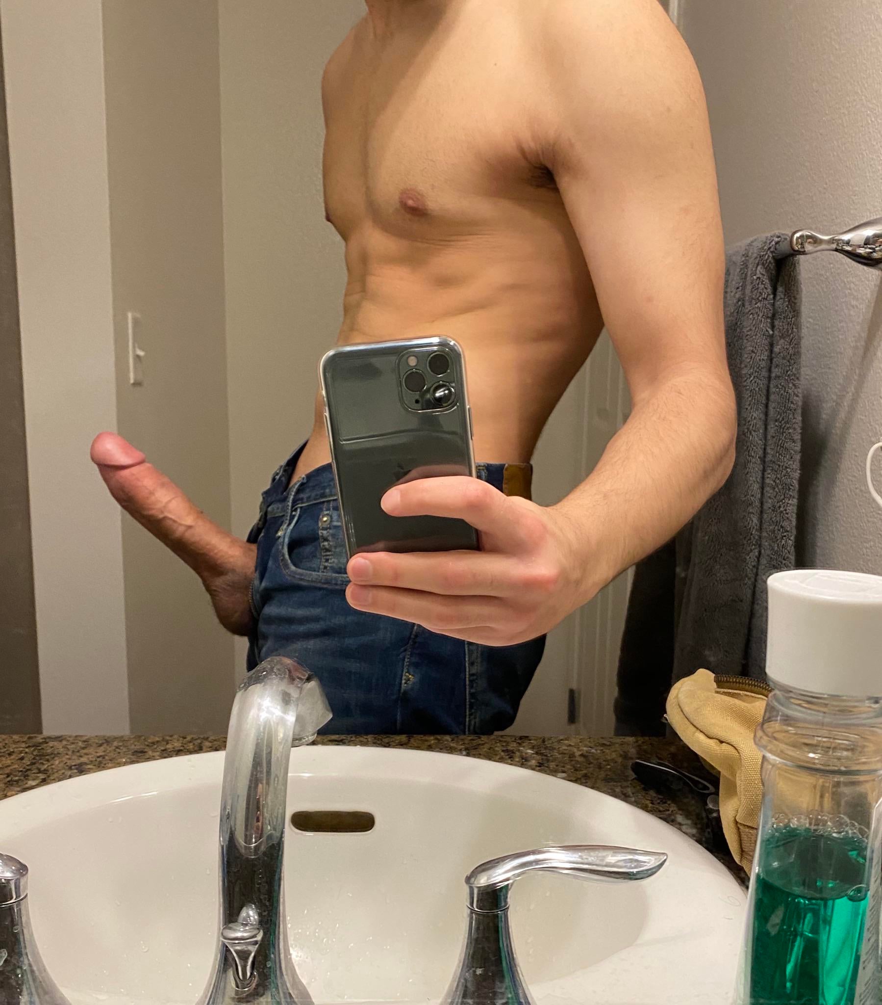 nude boy taking a mirror selfie