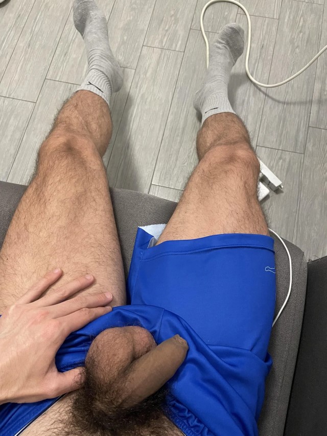 Sports guy pulls shorts down revealing flaccid uncut cock