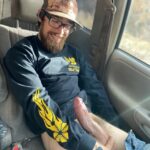 Cute bearded guy with glasses shows hairy cut cock in car