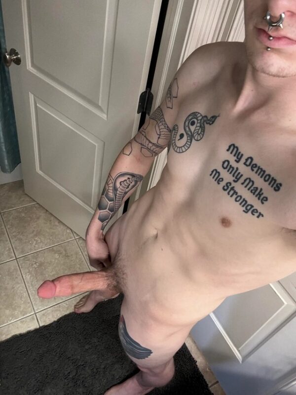 Tattoo guy with piercings shows big cut cock