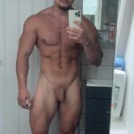 Very muscular guy shows his soft uncut cock